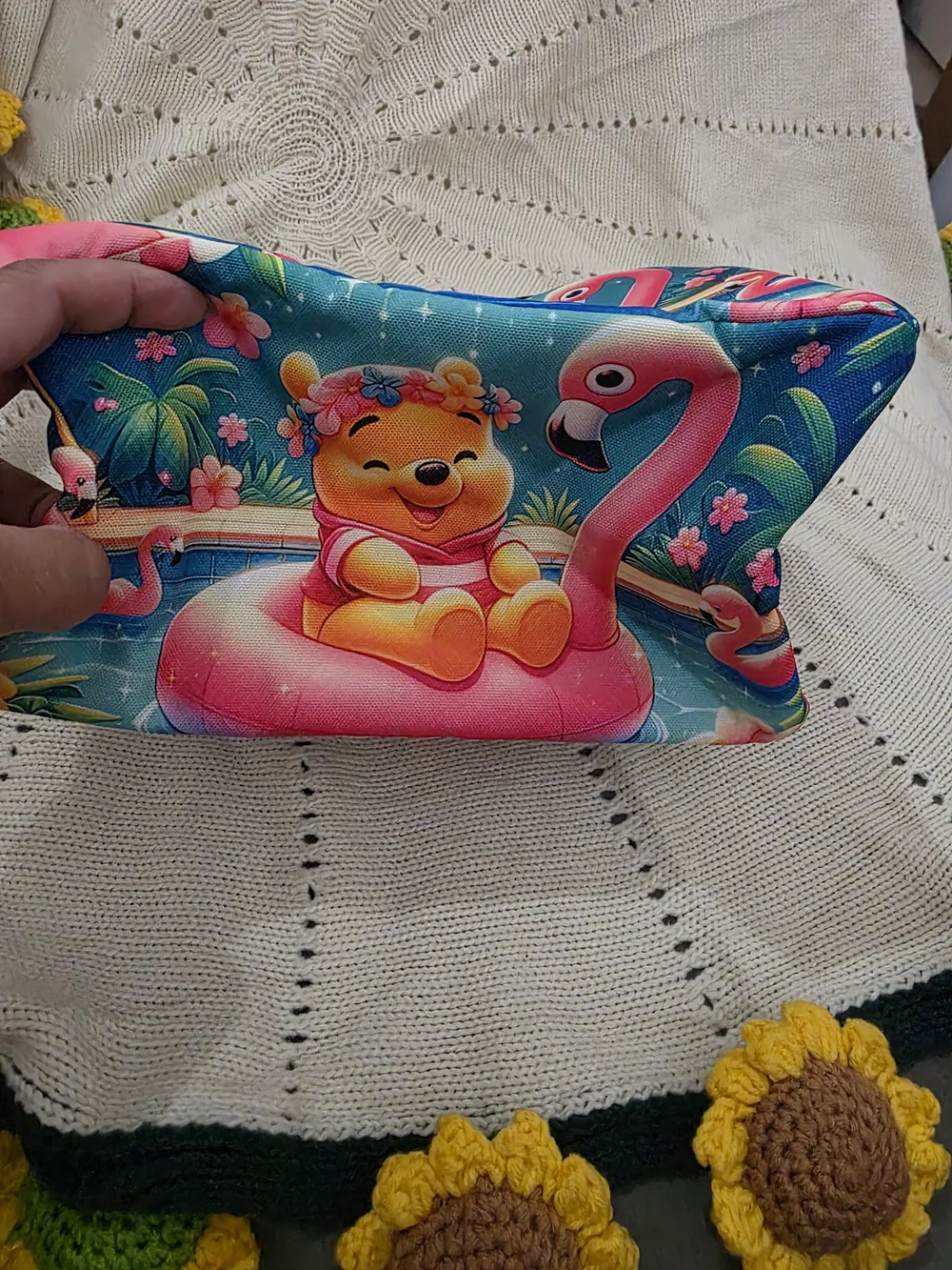Insulated lunch bag features a playful design of Winnie the Pooh wearing a color